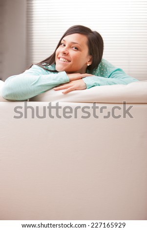 young woman thinking on her sofa about future or present