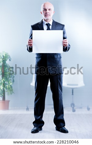 business man holding up a blank sign in which you can write your own text
