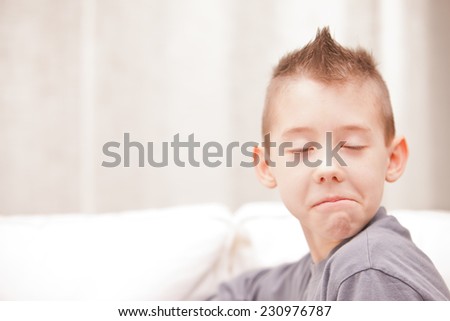 little kid making a funny face pretending to be a serious man very very disappointed