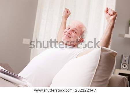 man stretching and going asleep in his living room but he could also exult, who knows