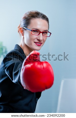 smiling skinny winning business woman with a red box glove