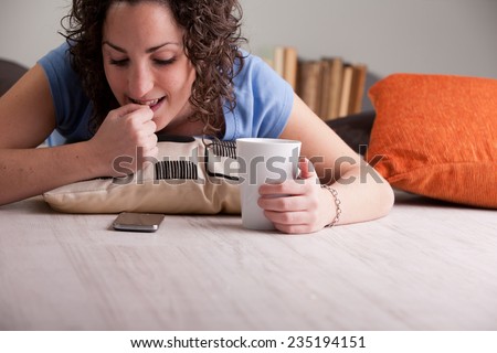 impatient girl nail-biting while she waits for a call or an answer to her chat or sms during her breakfast