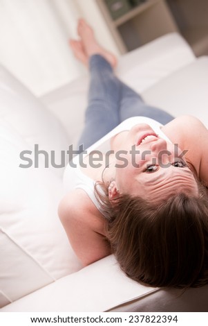 upside down smile of a nice girl on her couch