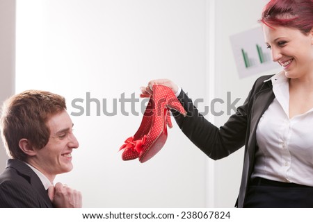 happy business man receiving lovely red high heels shoes