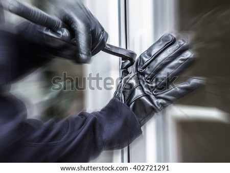 a burglar opens a window