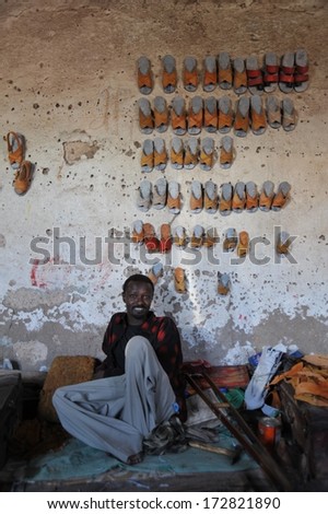 HARGEISA, SOMALIA - JANUARY14, 2010: In Somalia there is no social assistance to the poor. Persons with disabilities have organized a workshop for manufacturing of footwear of the tire Hargeisa