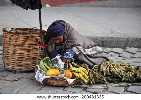 LA PAZ, BOLIVIA - SEPTEMBER 5, 2010: Large high city and actual capital in the Central part of South America. The majority of the population lives in poverty. Women selling on the street of La Paz.