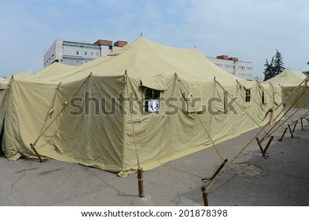 MOSCOW, RUSSIA - AUGUST 1, 2013:  Temporary camp for displaced persons contains illegal migrants from Asian countries, discovered during police raids, pending deportation to their homeland.
