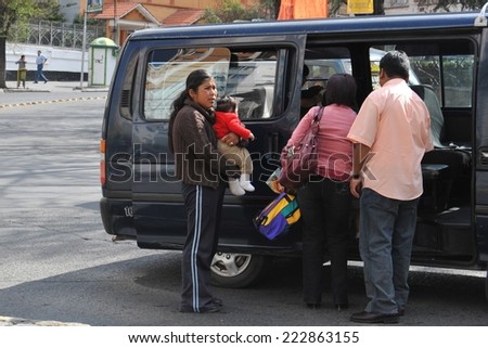LA PAZ, BOLIVIA - SEPTEMBER 11, 2010: Actual capital  of Bolivia. The majority of the population is illiterate. Therefore in public transport there are barkers who are shouting a bus route.