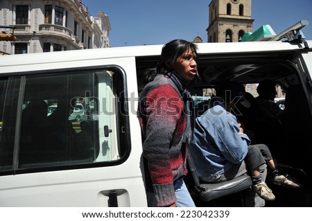 LA PAZ, BOLIVIA - SEPTEMBER 11, 2010: Actual capital of Bolivia. The majority of the population is illiterate. Therefore in public transport there are barkers who are shouting a bus route.