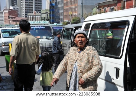 LA PAZ, BOLIVIA - SEPTEMBER 12, 2010: Actual capital  of Bolivia. The majority of the population is illiterate. Therefore in public transport there are barkers who are shouting a bus route.