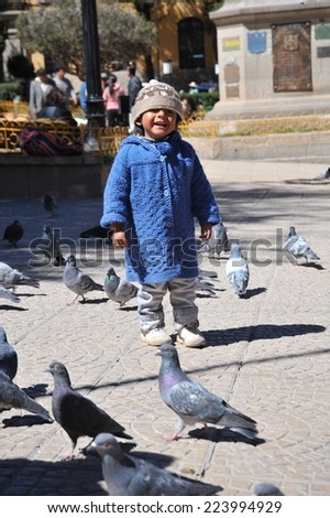 POTOSI, BOLIVIA - SEPTEMBER 8, 2010: Potosi is one of highest cities in world. History City is closely connected with extraction of rich deposits of silver. Unidentified child on street of Potosi