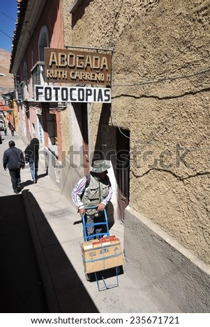 POTOSI, BOLIVIA - SEPTEMBER 7, 2010: Potosi is one of the highest cities in world. History City is closely connected with extraction of rich deposits of silver. Local inhabitants on the city streets