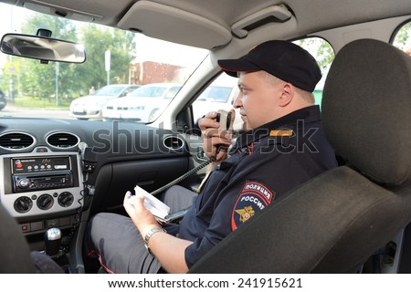 MOSCOW, RUSSIA - AUGUST 8, 2013:  Police in the patrol car. Patrol and inspection service of the police provides public safety in the capital.