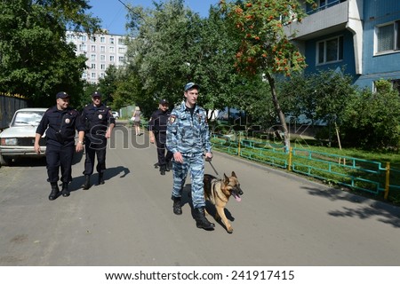 MOSCOW, RUSSIA - AUGUST 8, 2013: Police officers patrol the streets with dogs. Patrol and inspection service of the police provides public safety in the capital.