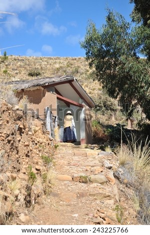 ISLAND OF THE MOON, BOLIVIA - SEPTEMBER 4, 2010 : Island  of the Moon is located on lake Titicaca. At the time of the Incas lived here in seclusion young women. Unknown woman on the island of the Moon