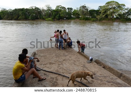GUAYABERO RIVER, COLOMBIA - NOVEMBER 5, 2012: Guayabero\'s river in Colombia, after merge to Arjyari form the deep river Guaviare.Transport artery the region.The locals on the river  Guayabero.