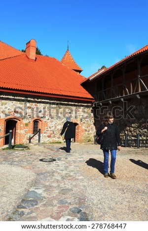 TRAKAI, LITHUANIA - SEPTEMBER 29, 2013:Tourists in the castle of Trakai.Medieval castle in Trakai, the first capital city of Lithuania. Is one of the most popular tourist attraction.