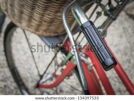 Vintage a red bicycle with weaving basket in front