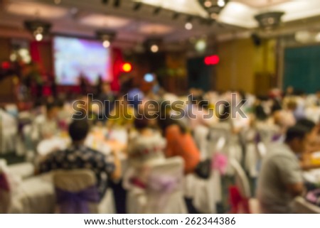 Abstract of blurred people sitting in banquet hall