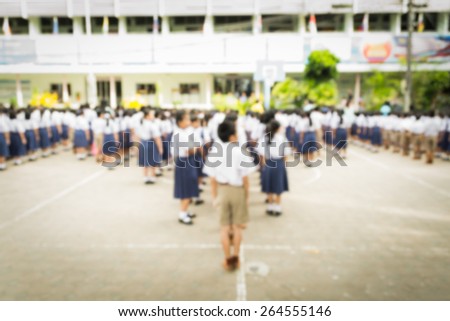 Abstract of blurred schoolchild standing in row in school