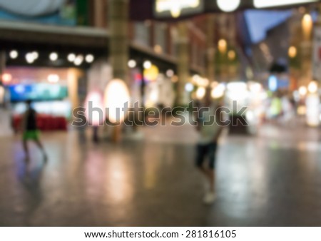 Abstract of blurred people walking in the shopping center at night