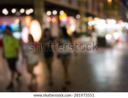 Abstract of blurred people walking in the shopping center at night