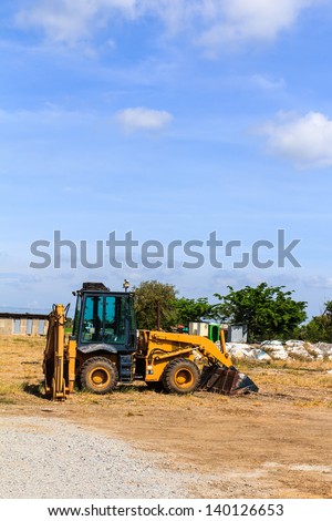 Crane truck parking in the field and sky background