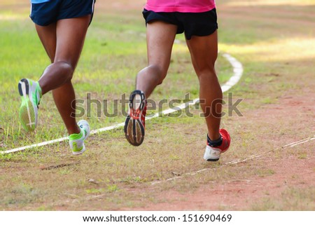 Two runners running in the urban field