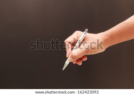 pen in the man hand isolated on black background