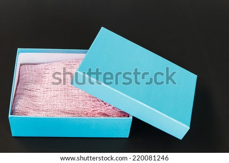 Light blue paper box isolated on black background
