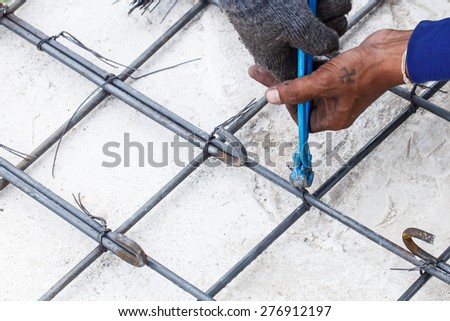 Construction worker with work in the cement formwork frames