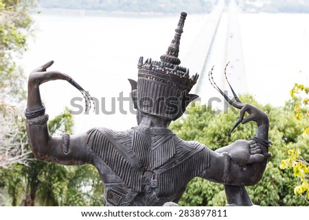 Back view of statue Nora statue with Tinsulanonda bridge view at Songkhla province-2