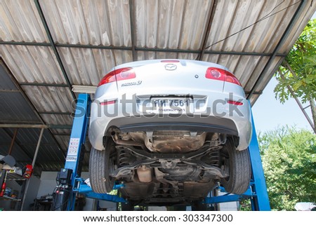 NONTHABURI , THAILAND -JULY 11 2015: Private car. Mazda 3 with orbital polisher in auto car repair shop. Photo at local repair shop Nonthaburi, thailand.