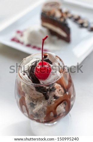 Hot fudge sundae on strawberry and chocolate ice cream