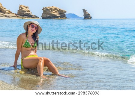 Young pretty woman in one of the most beautiful beaches in the world in Crete, Greece.