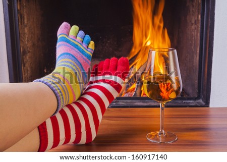 relaxing at fireplace in colorful funny toe socks