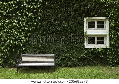 Old garden bench situated in a landscaped garden.