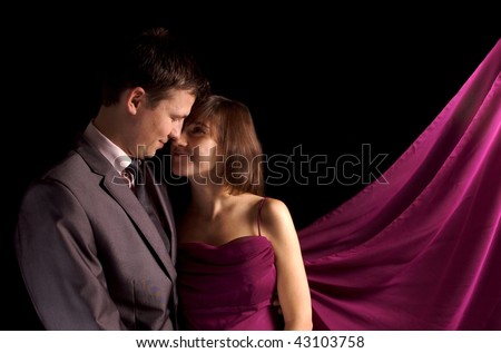 Young couple isolated on black wearing smart clothes