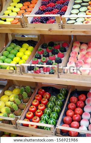 Market stand of decorative candles shaped tropical fruits