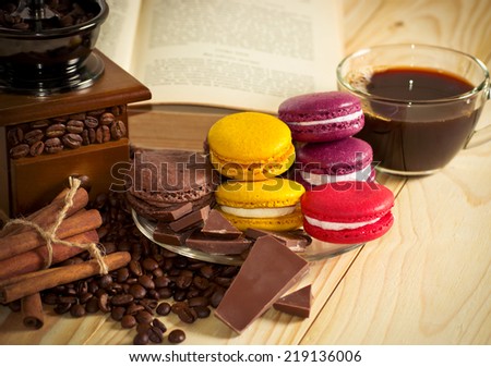 Coffee grain with macaroon, cinnamon and culinary book on the wooden table