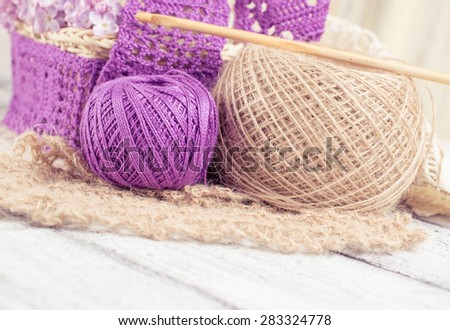 Yarn for crochet and knitted openwork napkins with lilac on shabby wooden boards