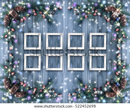 Christmas background with photo frames, illumination, glowing stars, spruce branches, pine cones, acorns. Winter holidays concept.