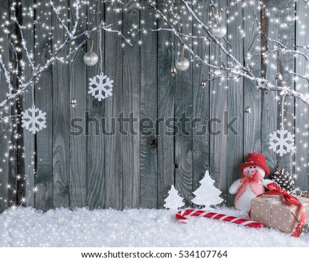 Christmas interior with decorative branches, presents and candy canes on wooden planks background. New Year winter composition.