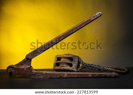 Ancient marine tools : compass and pulley with rope with yellow background