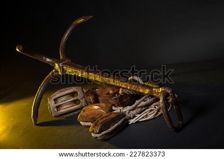 Ancient marine tools: Pulleys ropes, Anchor with yellow and black  background