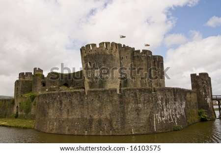 Caerphilly Castle with Welsh flags in South Wales, UK