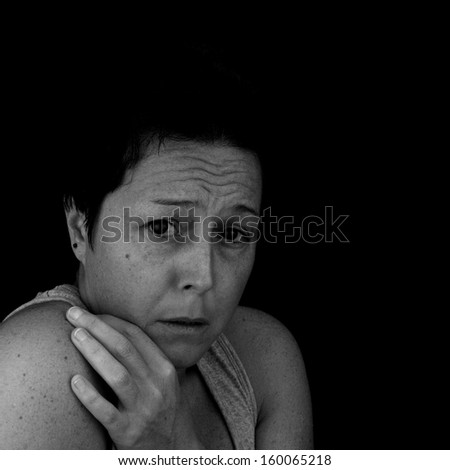 Scared, depressed woman. Black and white image.