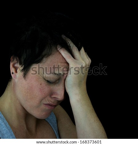 woman holding forehead in pain