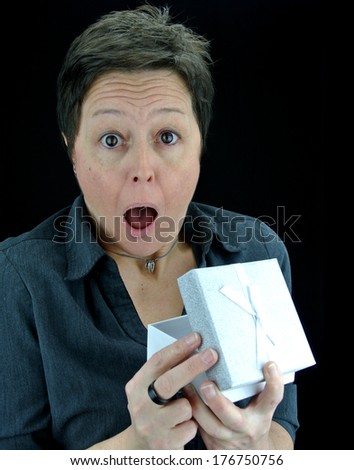 shocked woman opening a surprise present in gift box